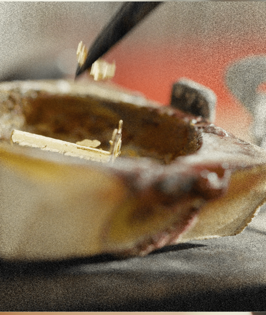 Handarbeit beim Goldguss: Präzise Platzierung von Goldteilen in der Gussform.